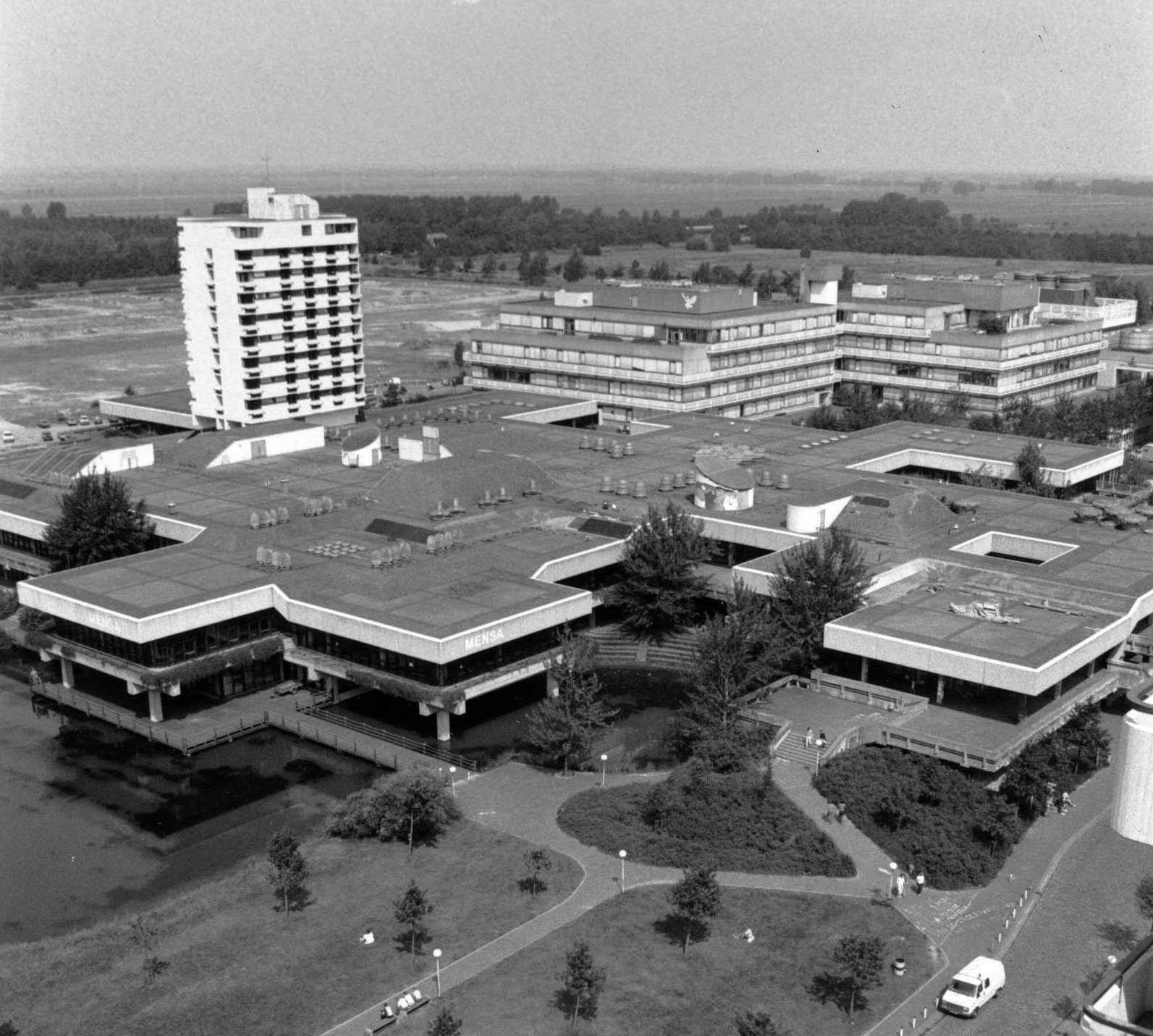 Blick aus Südosten vom Dach des Mehrzweckgebäudes auf die Mensa und das Dach des Boulevards. Dahinter ragt das Studierendenwohnheim heraus sowie die zwei zueinander versetzten Quader des Gebäudes Naturwissenschaften 2.